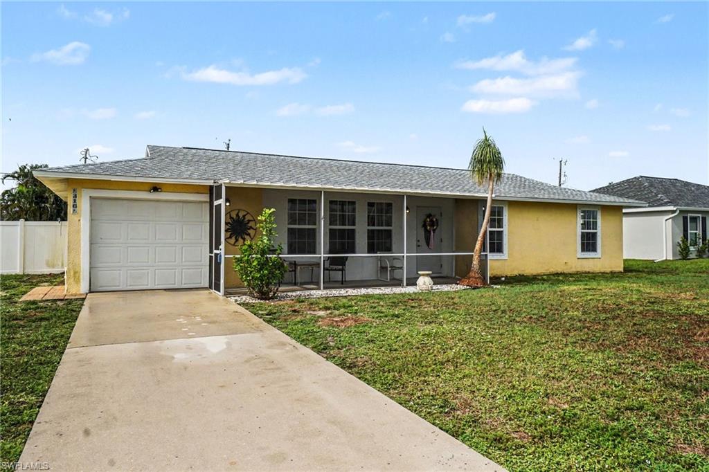 Single-story residence featuring a screened front porch, an attached garage, and a concrete driveway