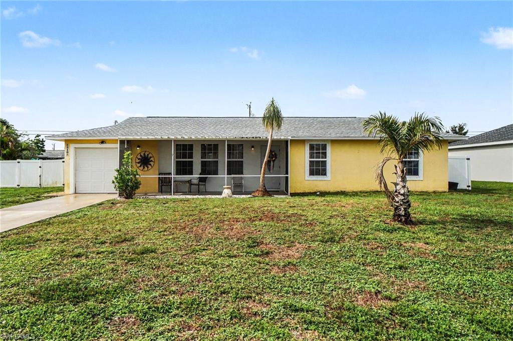 Single-story residence featuring a yellow exterior, white trim, and a gray shingle roof