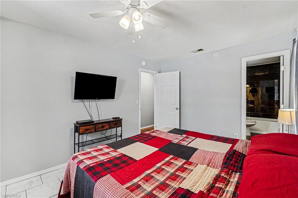 Light gray walls featuring a white ceiling fan with integrated lighting
