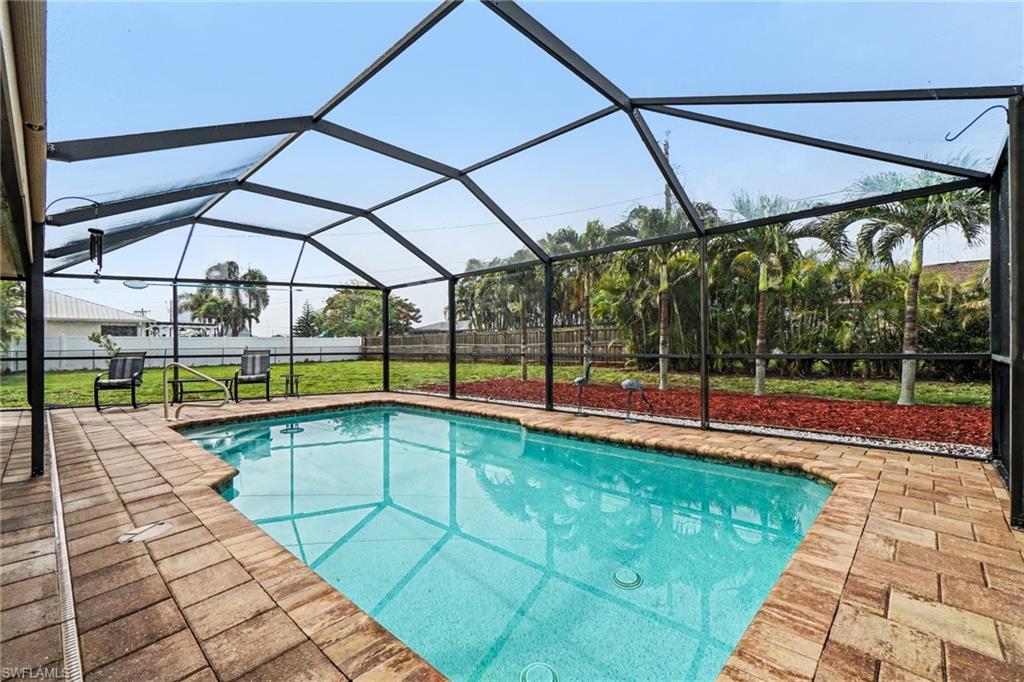 Screened pool enclosure featuring an in-ground swimming pool with a textured bottom