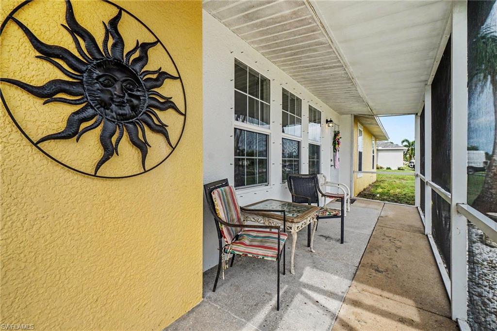 Screened porch featuring a concrete floor, textured exterior wall, and multiple windows