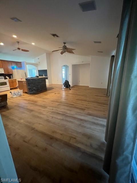 Living room with ceiling fan and hardwood / wood-style floors