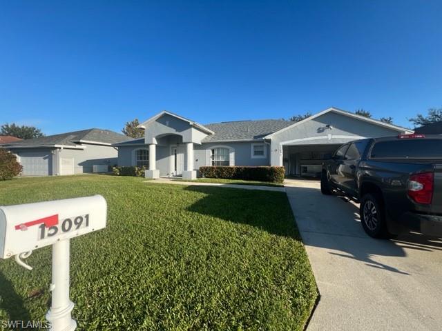 Ranch-style home with a garage and a front lawn