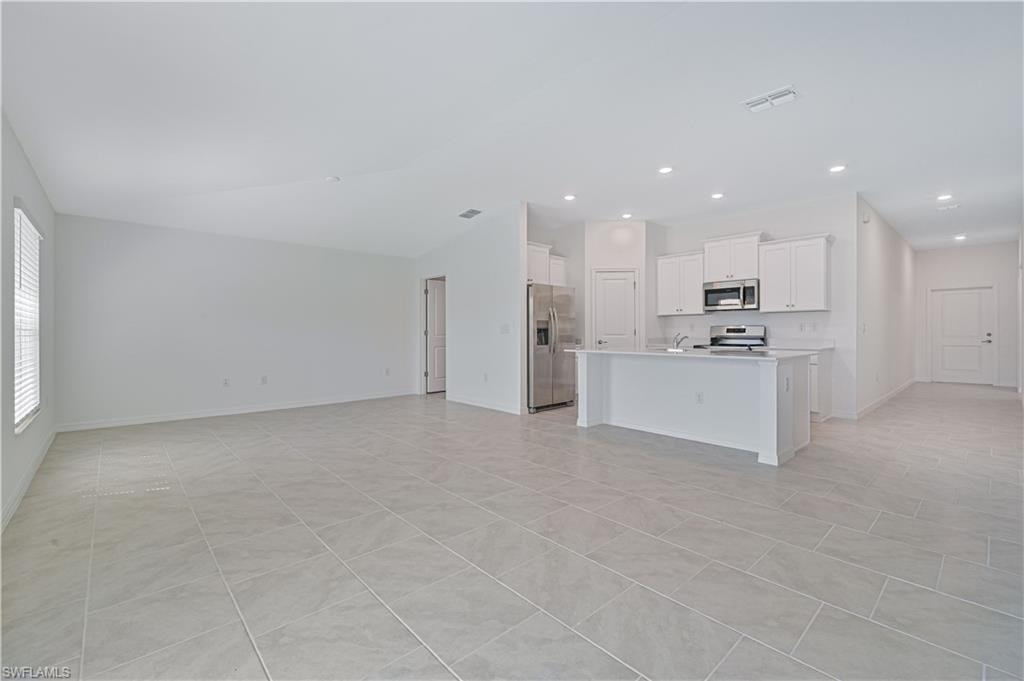 Unfurnished living room with light tile patterned floors