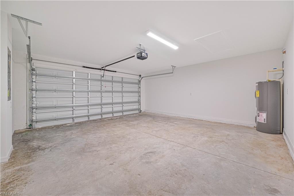 Garage featuring water heater and a garage door opener