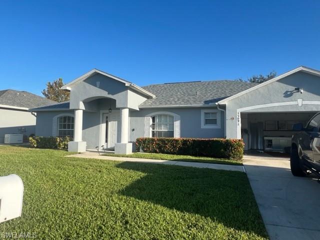 Ranch-style house with a garage and a front yard