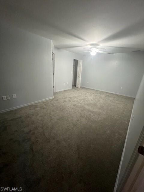 Unfurnished room featuring carpet and ceiling fan