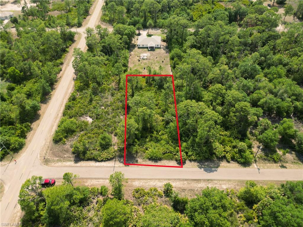 Aerial view of property and surrounding area featuring property boundaries highlighted