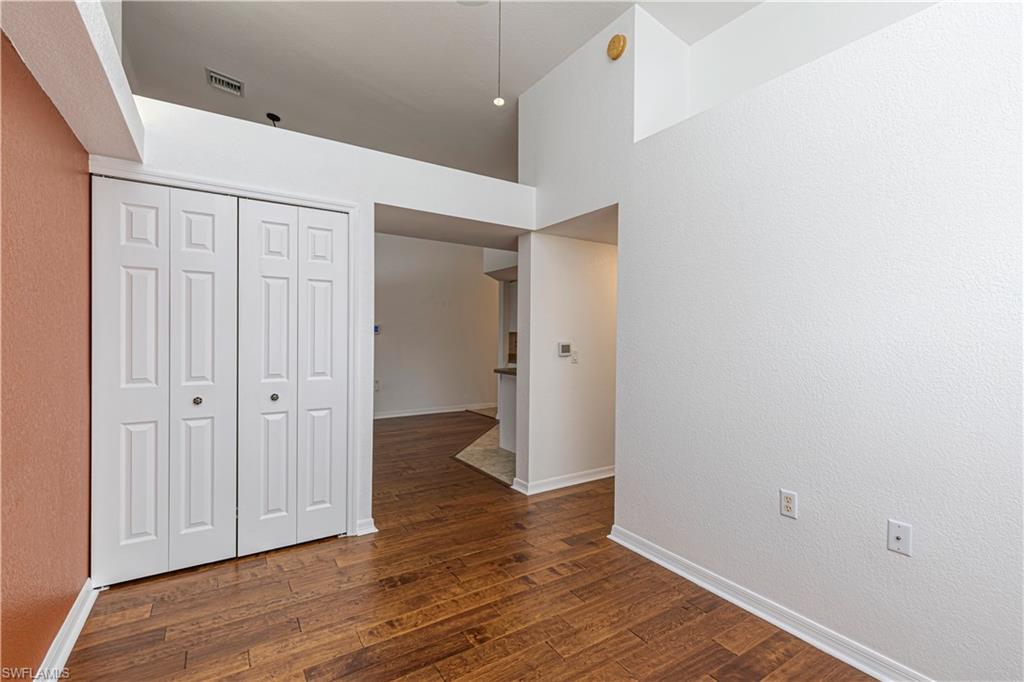Spacious den with closet which could also be used as a guest bedroom which features a large window and hardwood floors.