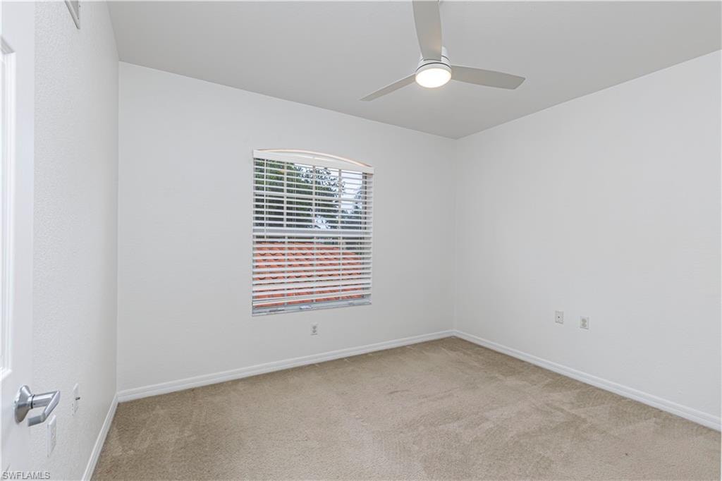 2nd Bedroom featuring a window with blinds, a ceiling fan with integrated lighting, and neutral carpeting