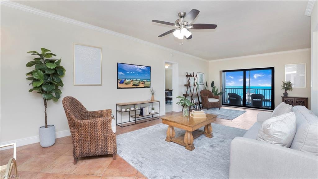 Living area featuring light tile patterned flooring, ornamental molding, and a ceiling fan