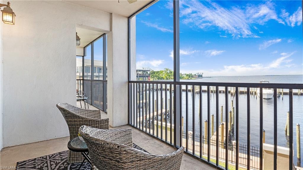 Balcony with a water view and a sunroom