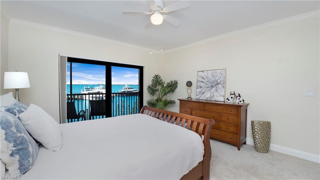 Bedroom featuring a water view, ornamental molding, light colored carpet, access to outside, and ceiling fan