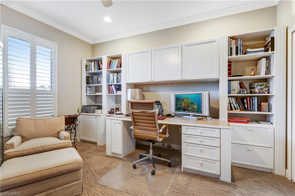 4th bedroom utilized as an office with beautiful plantation shutters and a built in desk with lots of storage