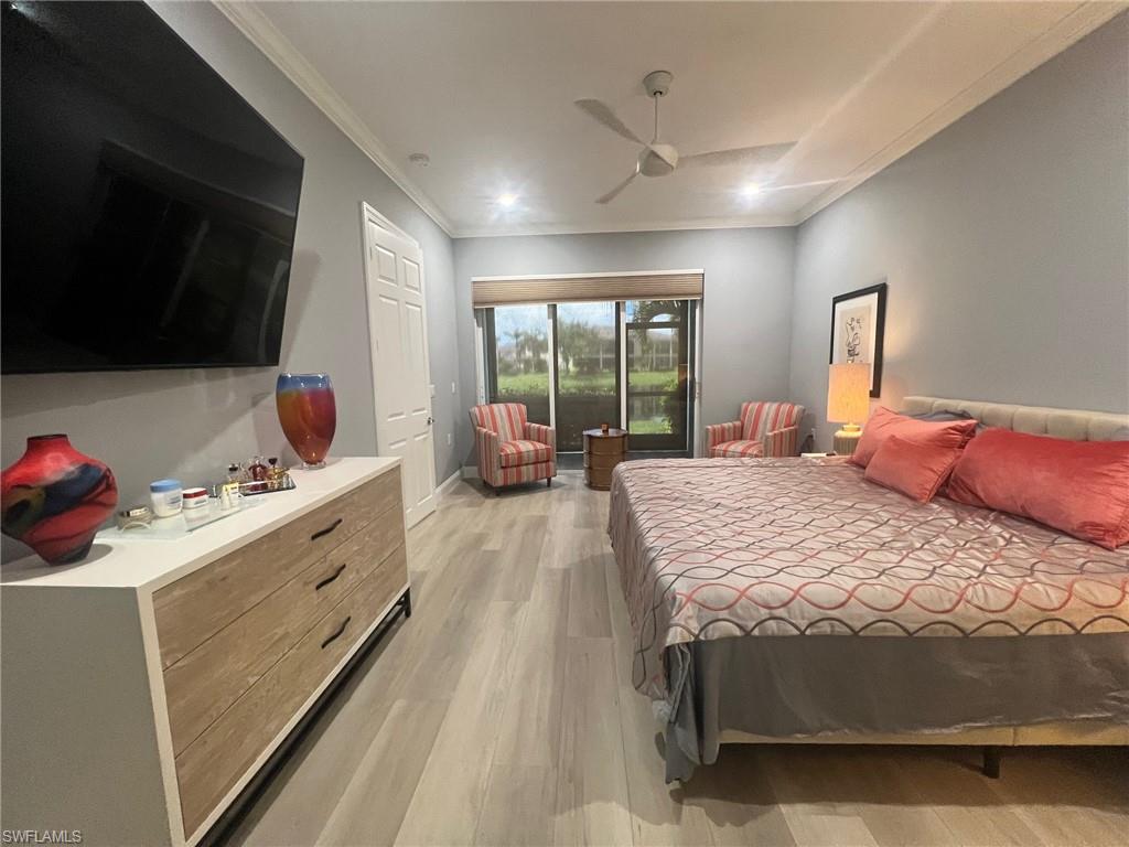 Bedroom with ceiling fan, light hardwood / wood-style flooring, and crown molding