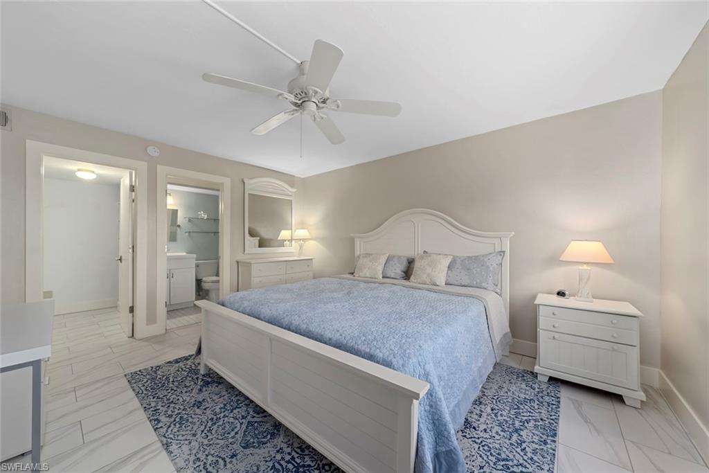 Spacious room featuring light-toned walls and wood-finish flooring