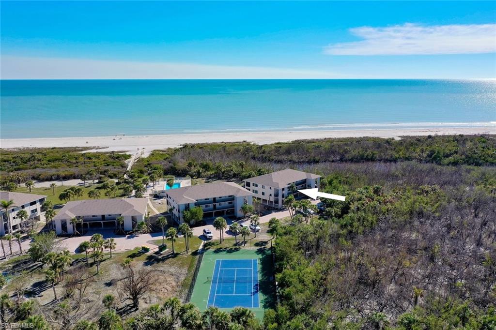 Coastal condominium building with balconies overlooking the beach and Gulf of Mexico