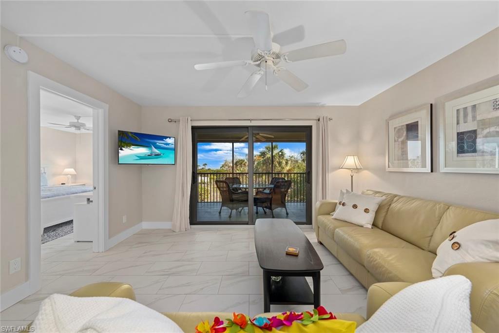 Living area featuring light-toned flooring and a ceiling fan