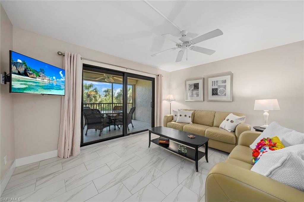 Living area featuring large format tile flooring and direct access to an outdoor screened patio