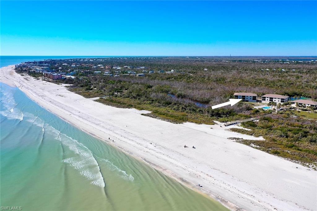 Expansive beachfront property featuring a multi-building complex, private pool, and direct access to the white sand beach