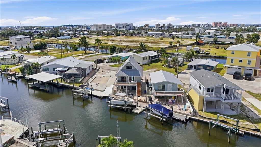 Waterfront property featuring multiple boat slips, a covered dock, and direct canal access