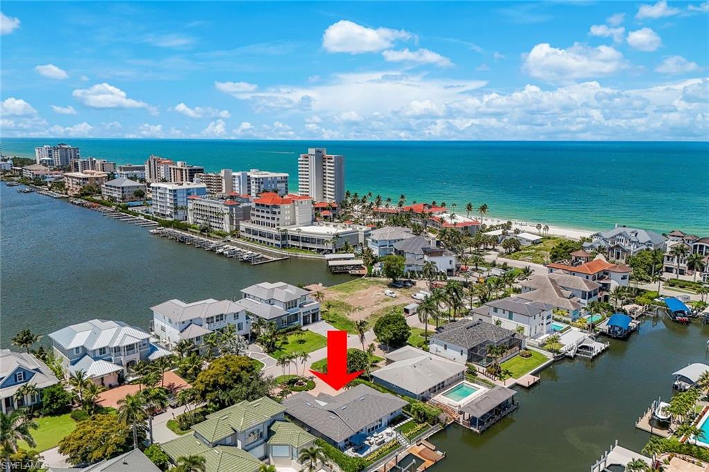 Waterfront property featuring a private boat dock, pool, and direct canal access