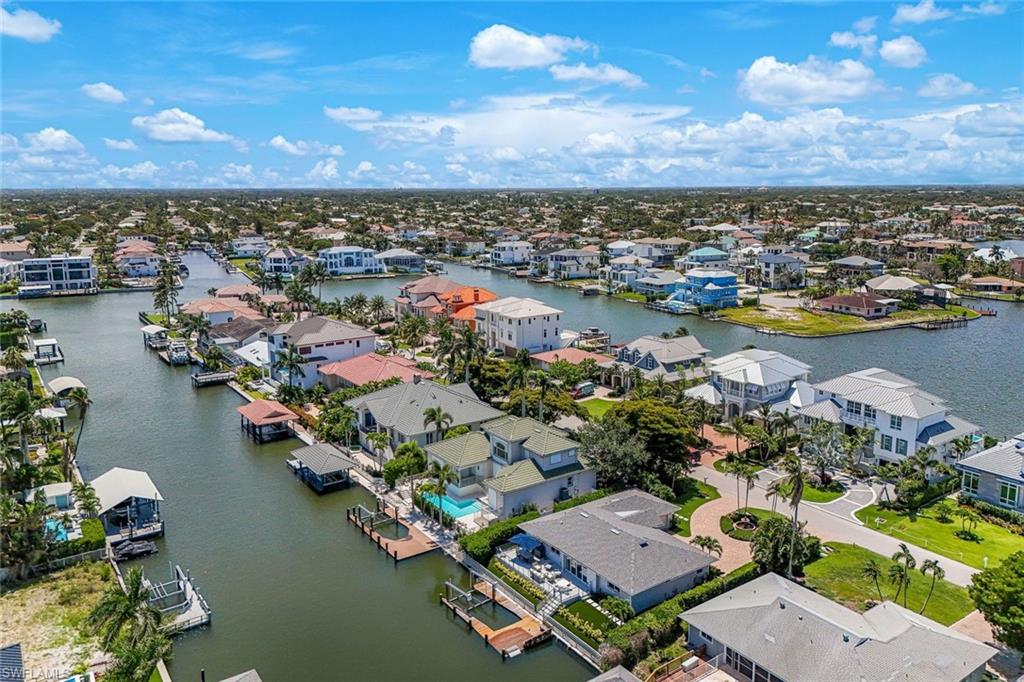 Aerial perspective of a waterfront residential area featuring numerous properties with private docks