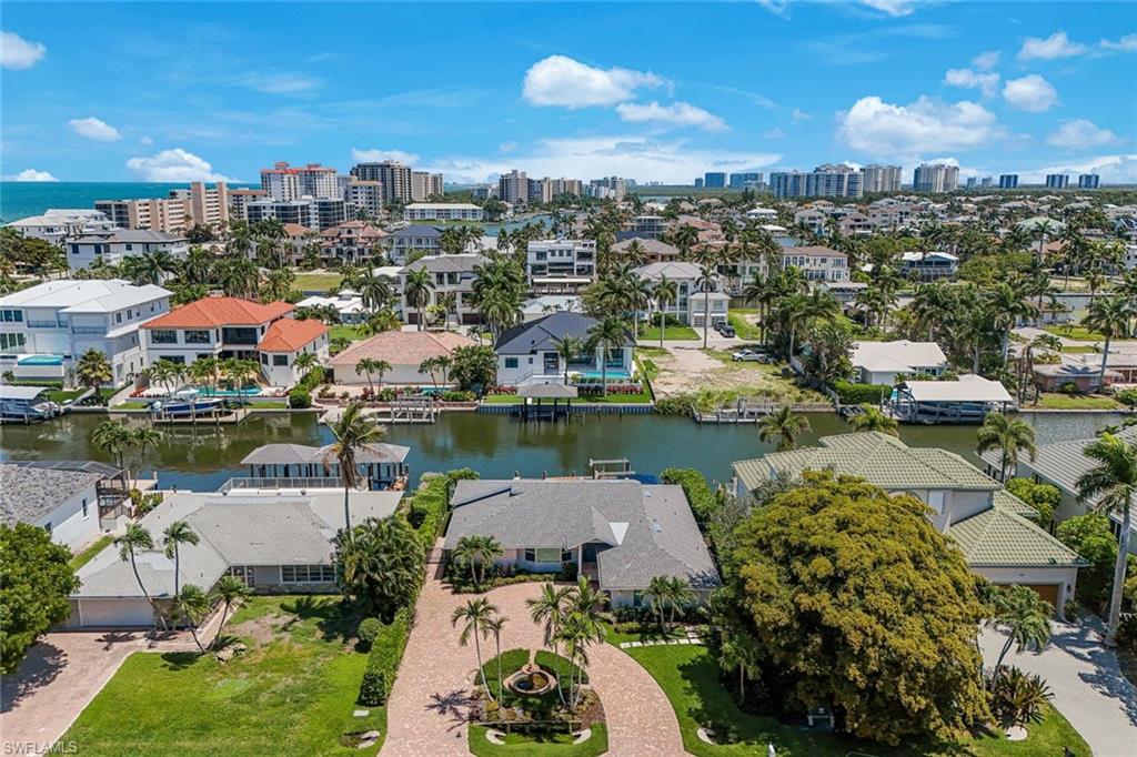 Coastal canal-front property featuring a private boat dock