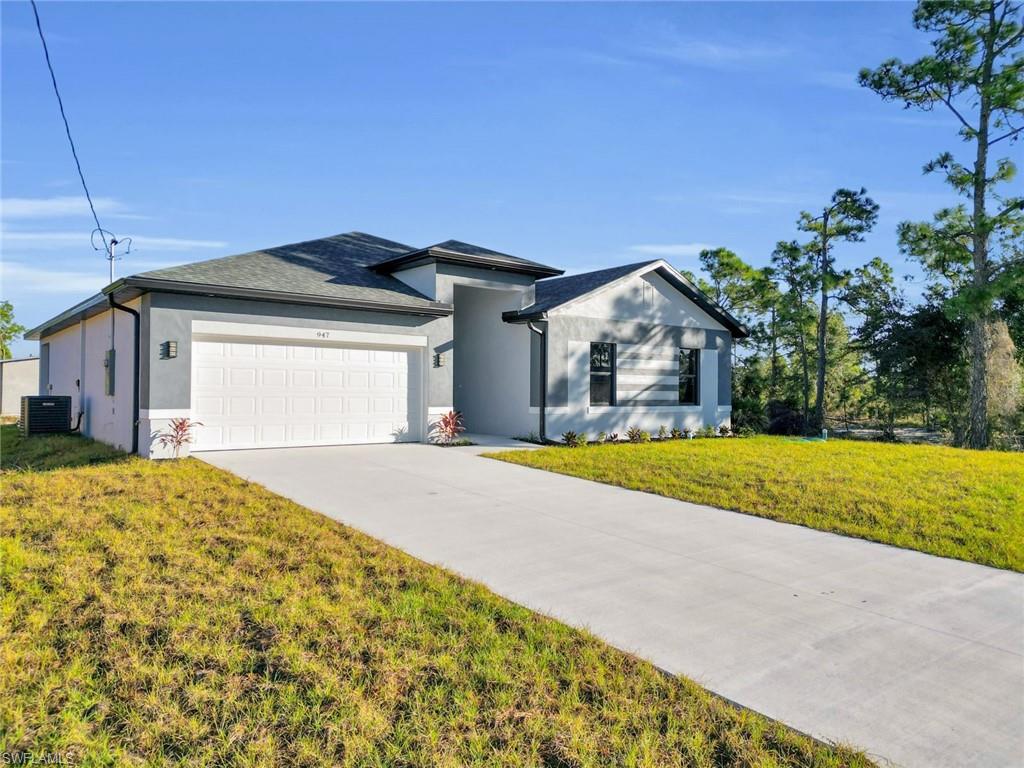 Contemporary single-story residence with a two-tone gray and white stucco exterior