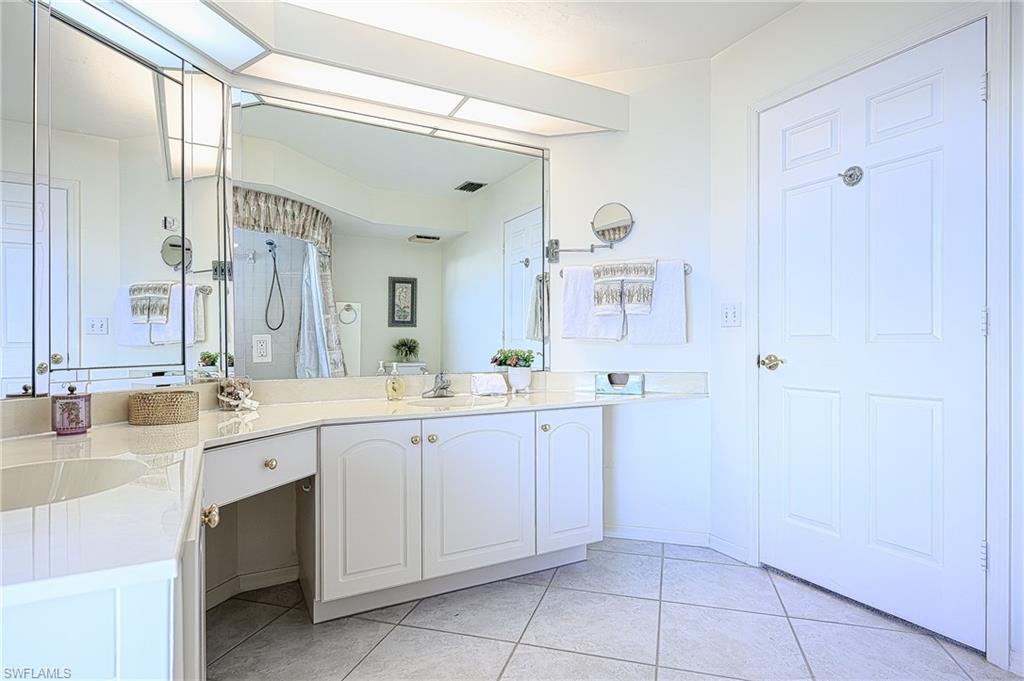 Full bath with vanity, tile patterned floors, and a shower with curtain