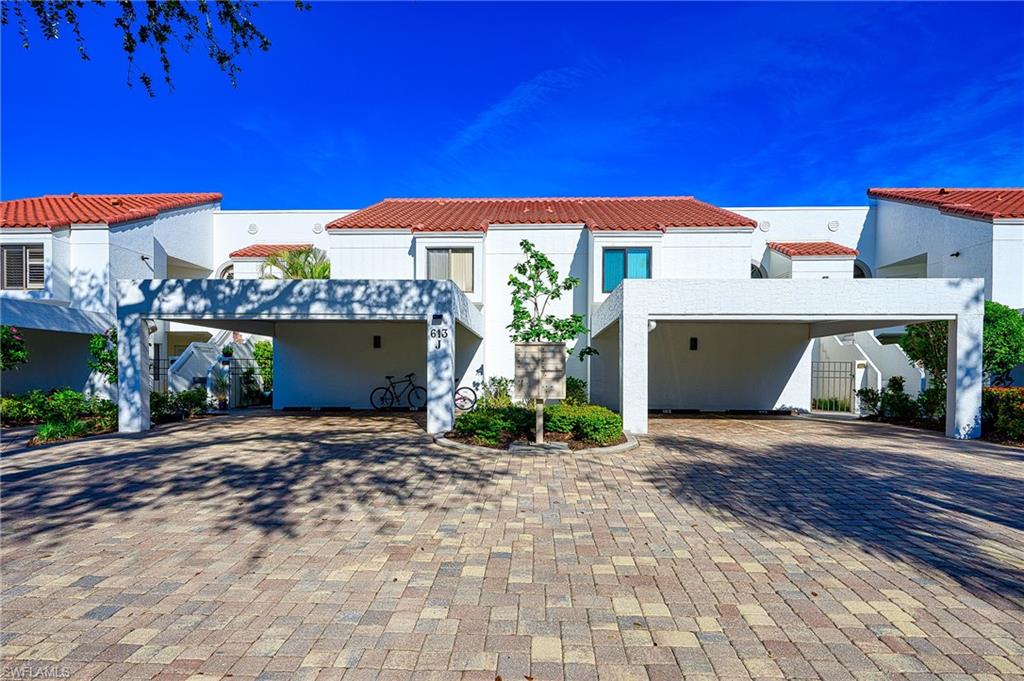 Mediterranean / spanish home featuring a tile roof, stucco siding, and stairs