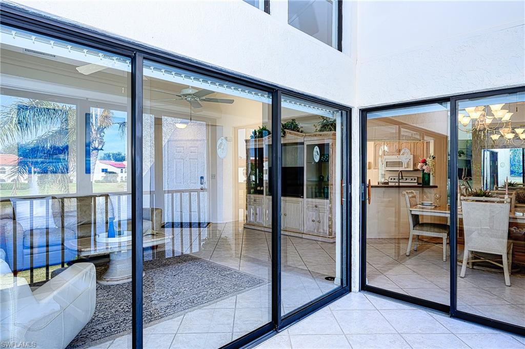 Doorway to outside with a chandelier and tile patterned floors