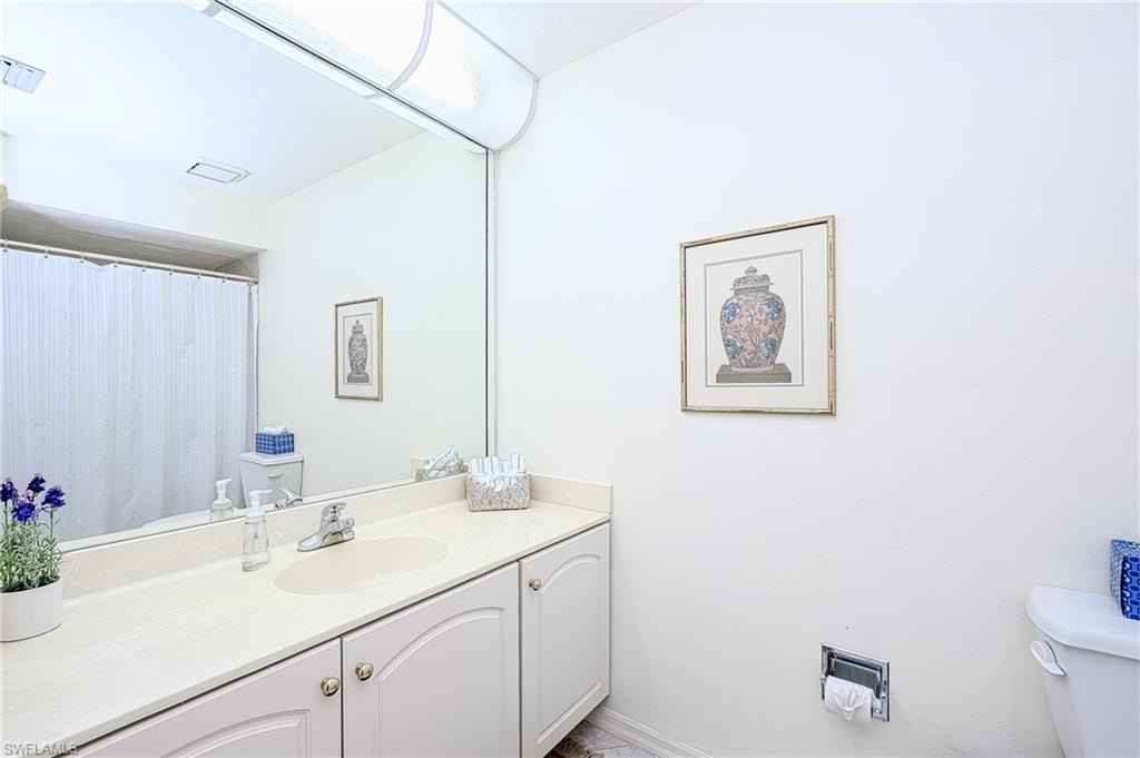 2nd bathroom featuring tub, toilet and vanity