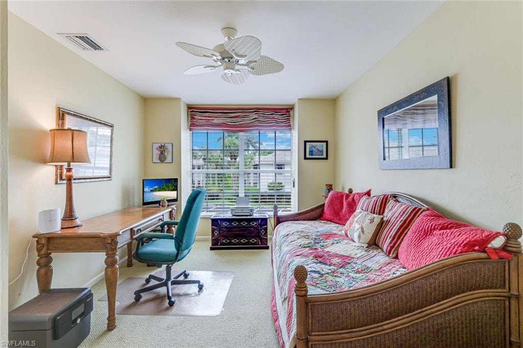 Carpeted room featuring a ceiling fan, a window with horizontal blinds, and light-toned walls