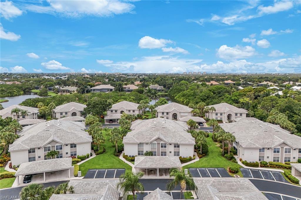 Expansive aerial showcasing multiple residential buildings with uniformly tiled roofs