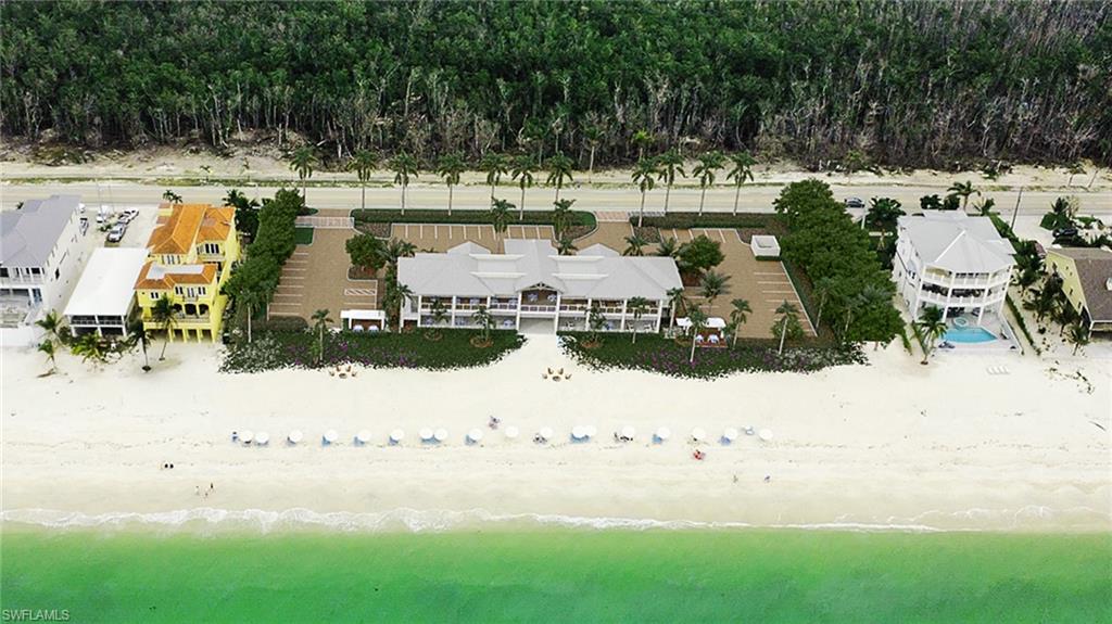 Coastal property featuring direct beach frontage with white sand and clear turquoise water