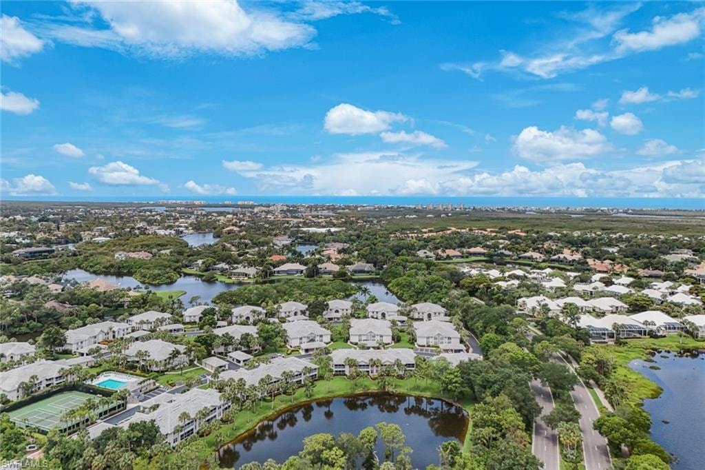 Expansive aerial perspective showcasing a residential community with multiple lakes and mature trees