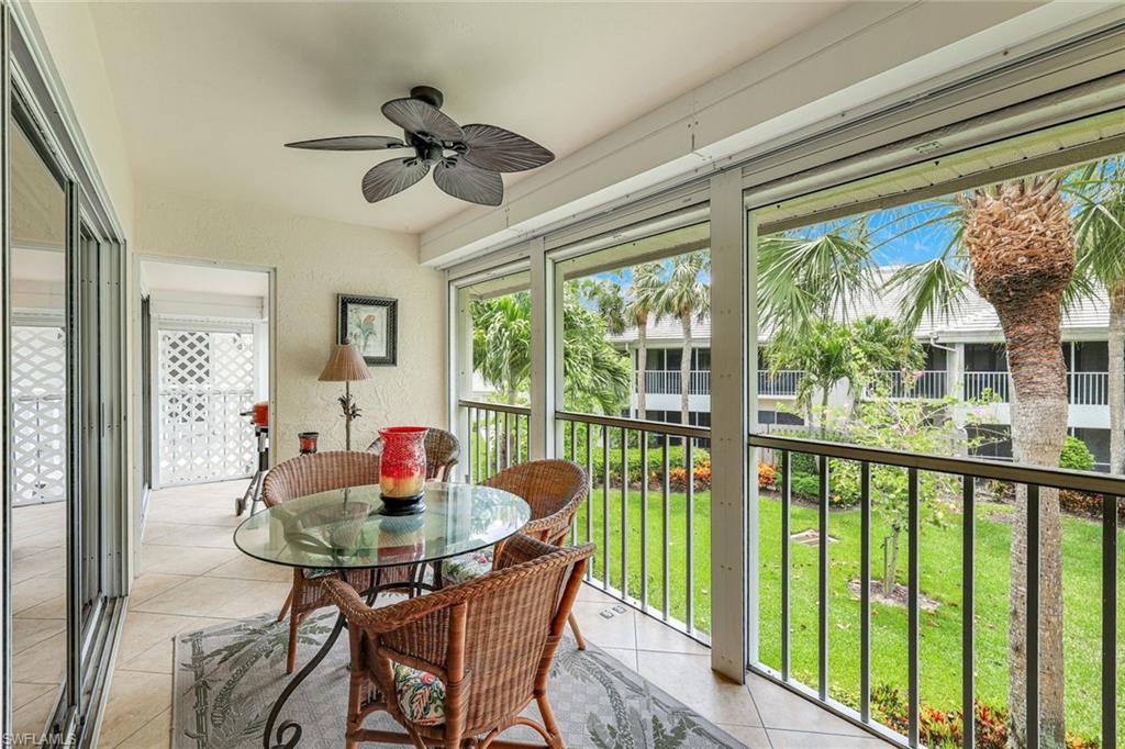 Screened lanai featuring tile flooring, a ceiling fan, and sliding glass doors