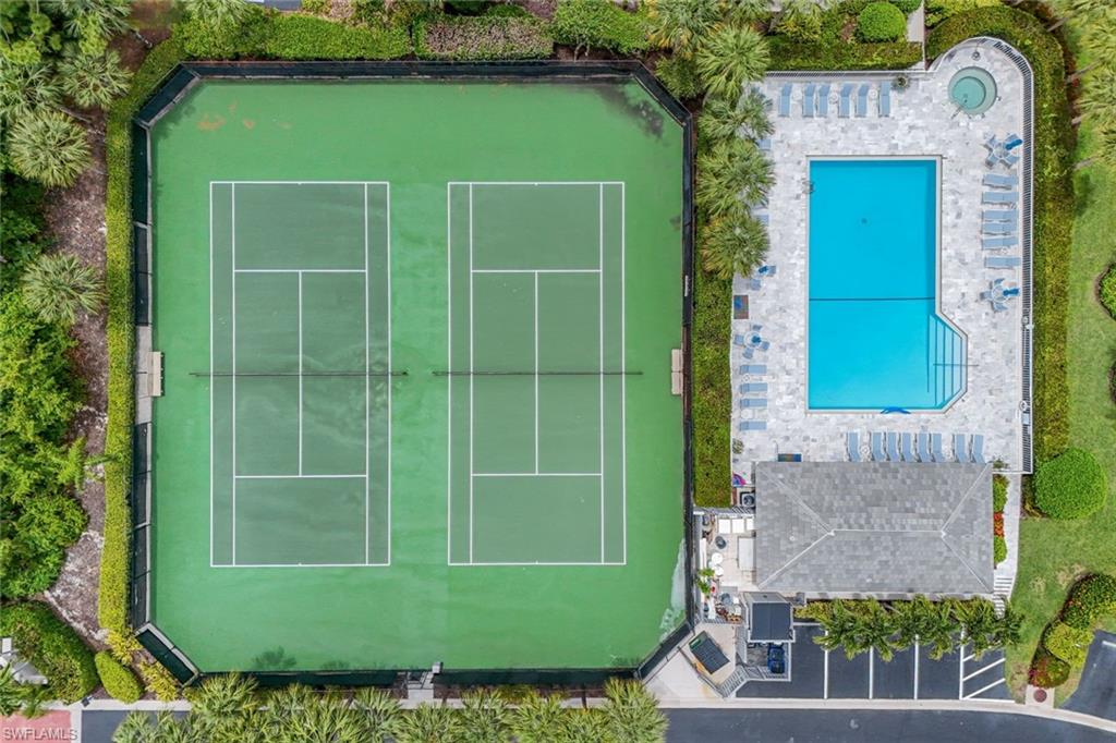 Two full-sized tennis courts, a rectangular swimming pool, and an integrated spa