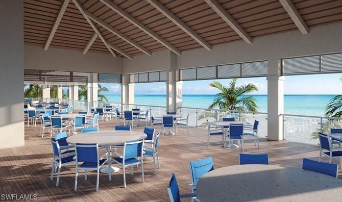 Spacious open-air dining area with a pitched wood-finish ceiling, wood-finish flooring, and glass panel railings