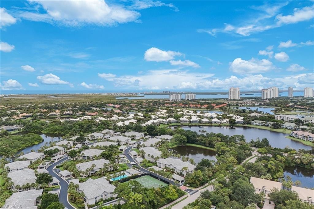 Aerial panorama showcasing a residential community with abundant mature trees and multiple tranquil lakes