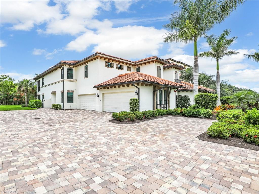 Mediterranean / spanish home featuring stucco siding, decorative driveway, a tile roof, and a garage