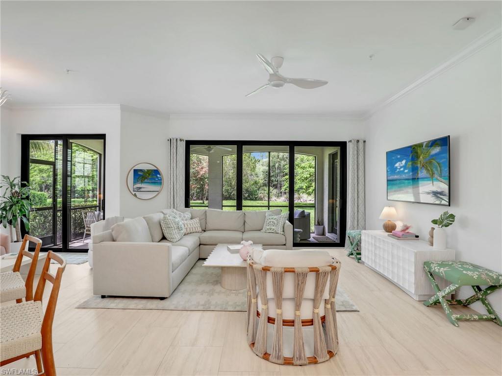 Living room with crown molding and ceiling fan