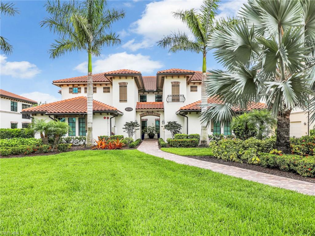 Mediterranean / spanish house with stucco siding, a front yard, and a tiled roof