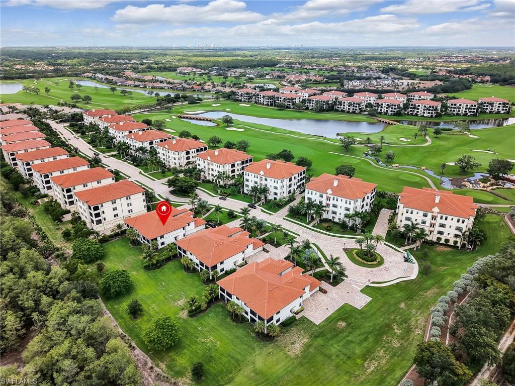 Bird's eye view of a golf course, a large body of water, and apartment complex