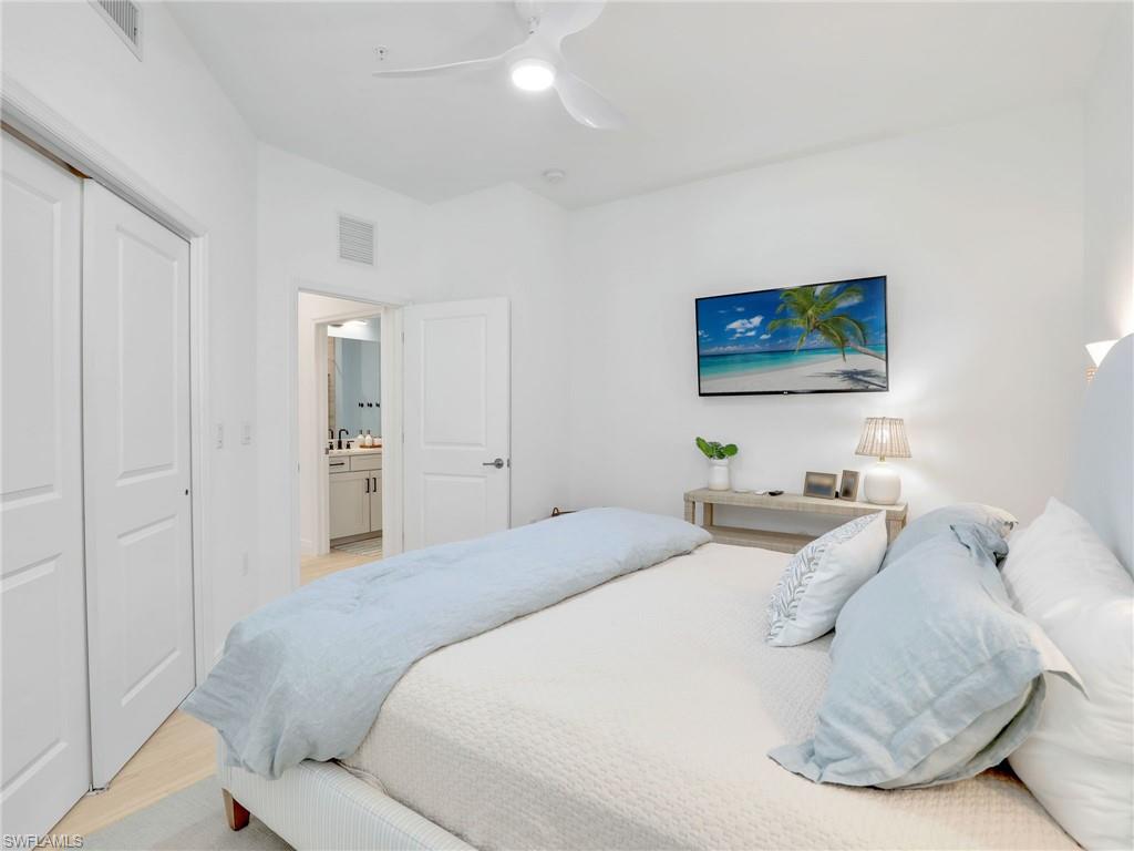Bedroom featuring light wood-style flooring, a closet, and ceiling fan