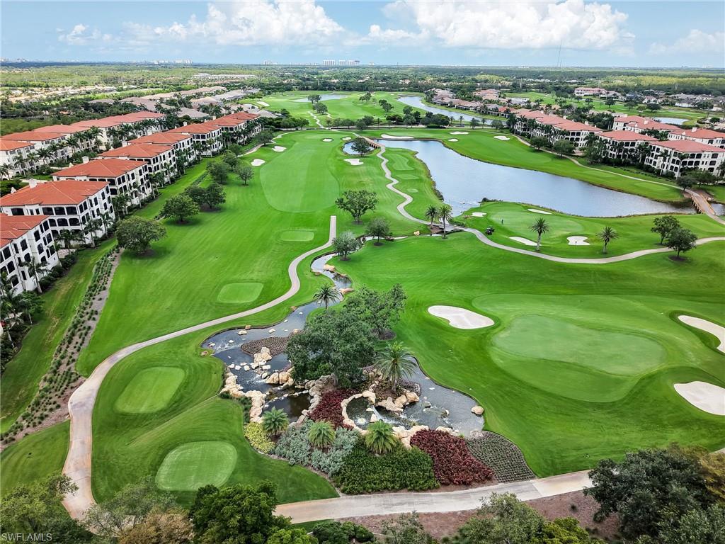 Aerial perspective of suburban area featuring a golf club and a large body of water