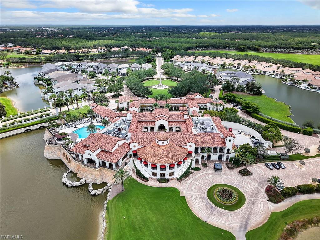 Aerial view of residential area with a nearby body of water and a pool area