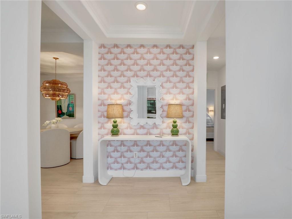Corridor with crown molding and recessed lighting