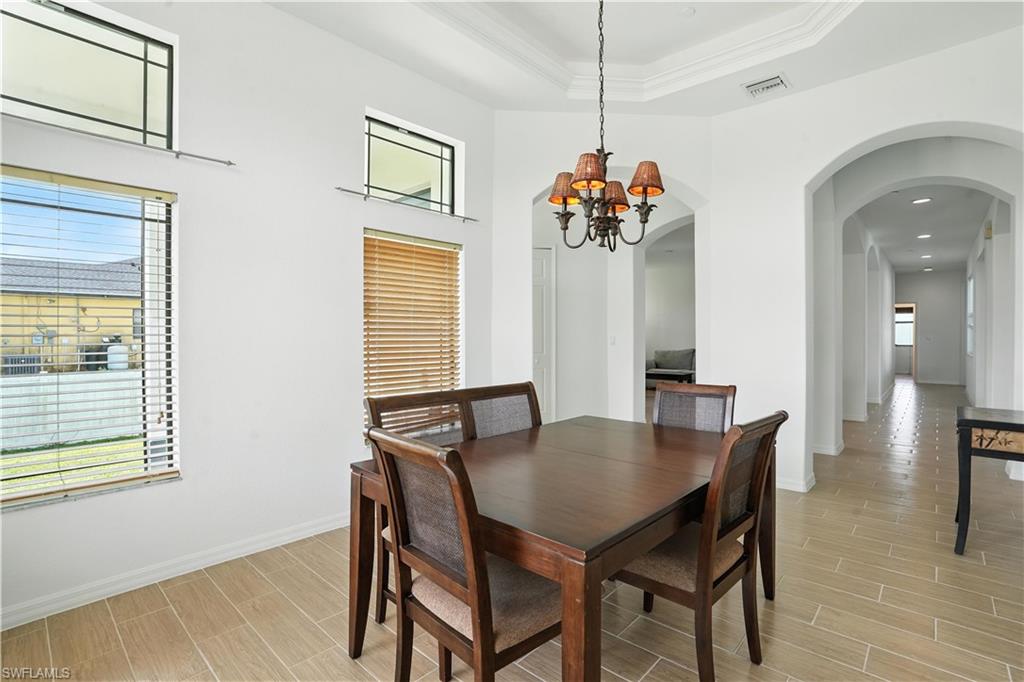 Dining area featuring a decorative chandelier and crown molding